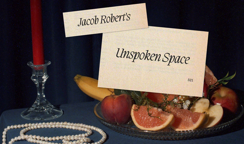 text unspoken space, a platter of fruit and a string of beads on a table